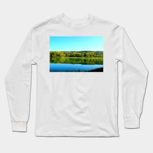 View from Lago Cedri in Lapedona with the surface of water extending over the picture and reflecting vegetation Long Sleeve T-Shirt